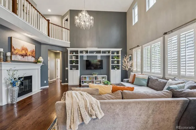 a living room with furniture large window and flat screen tv