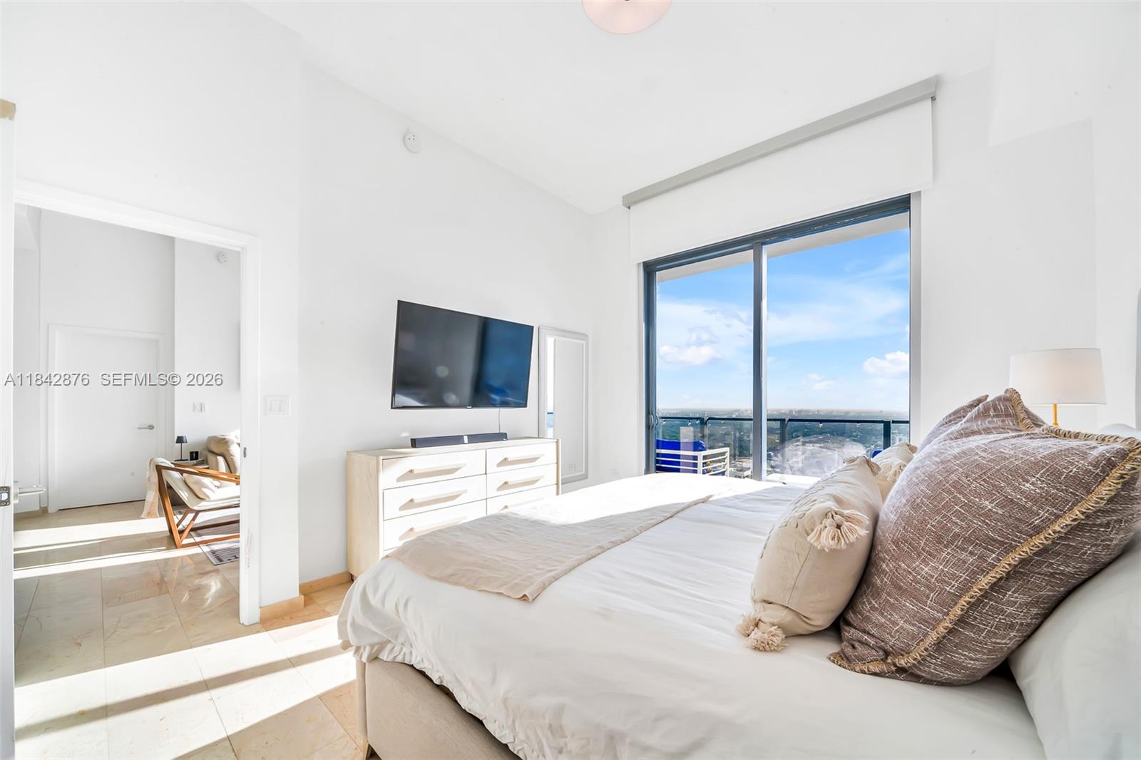 88 Southwest 7th Street, Unit 4004 Miami, FL 33130 - Photo 11 of 24 a bedroom with a bed and a flat screen tv