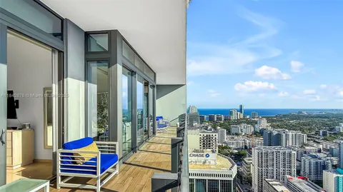 a bedroom with furniture and a large window