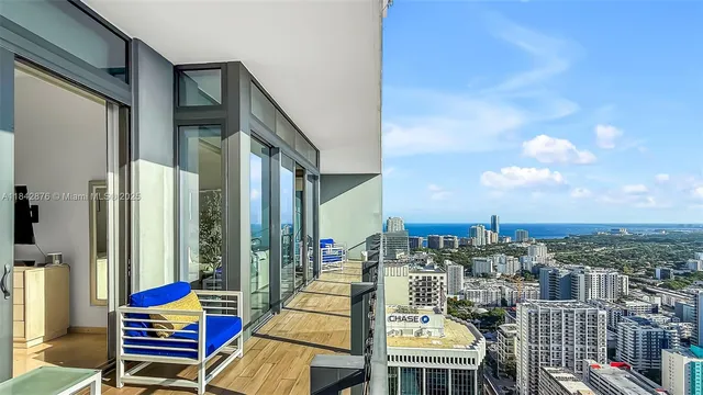 a bedroom with furniture and a large window