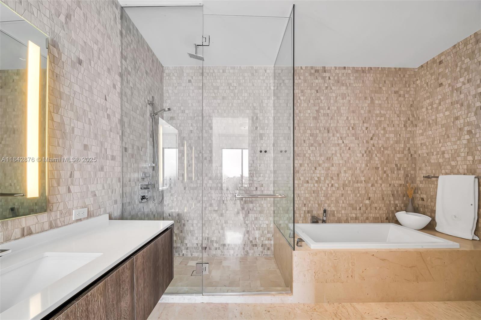 88 Southwest 7th Street, Unit 4004 Miami, FL 33130 - Photo 13 of 24 a bathroom with a granite countertop sink a toilet a mirror and bathtub