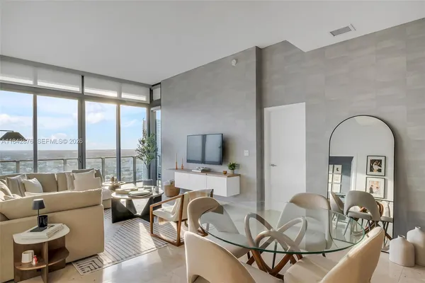a living room with furniture and a large window