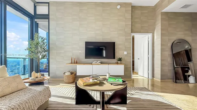 a view of a livingroom with furniture and a large window