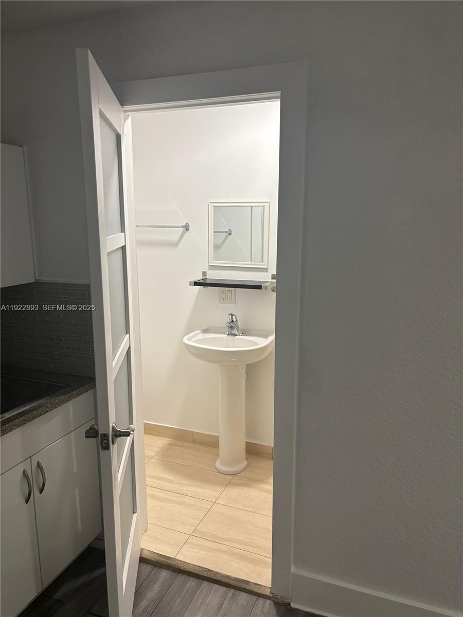 15535 Southwest 10th Street, Unit EFFICIENCY Miami, FL 33194 - Photo 8 of 10 a bathroom with a sink and a mirror