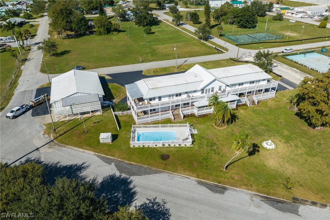 300 1st Street Moore Haven, FL 33471 - Photo 12 of 45 an aerial view of a house with a garden and lake view