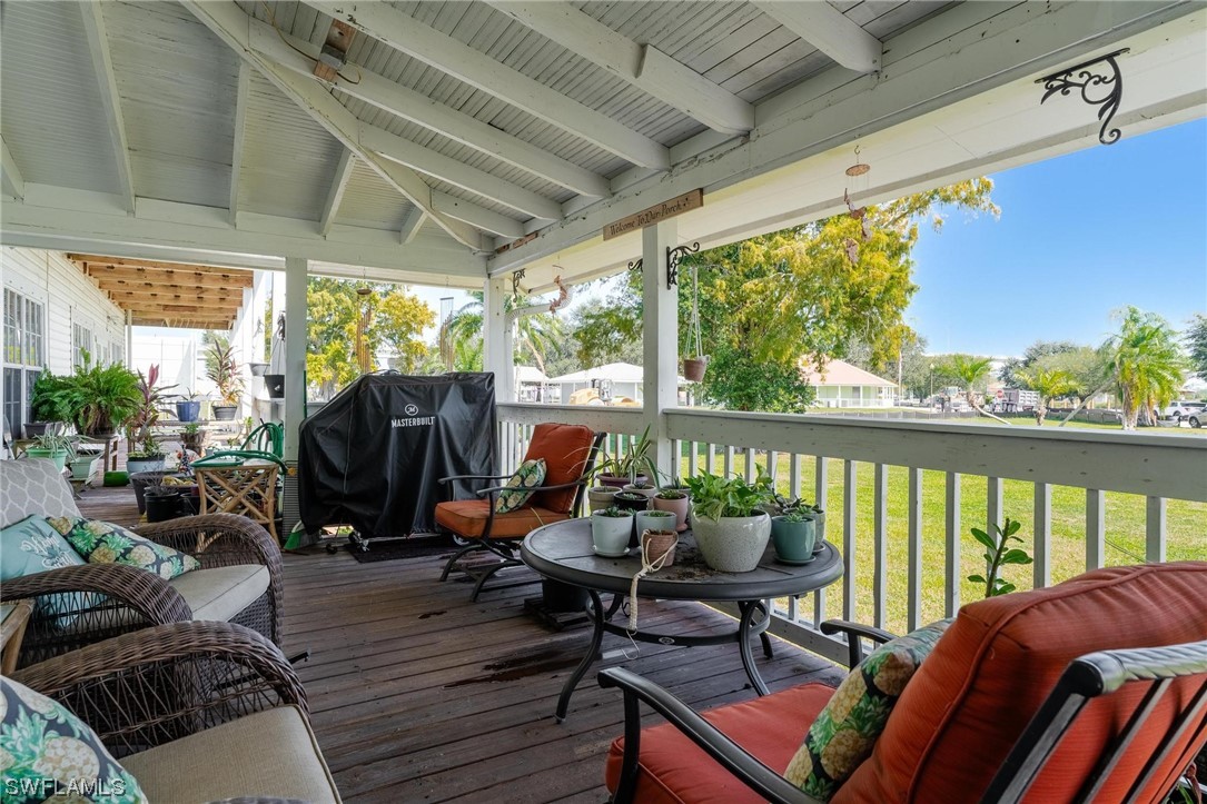 300 1st Street Moore Haven, FL 33471 - Photo 18 of 45 a balcony with wooden floor and outdoor seating