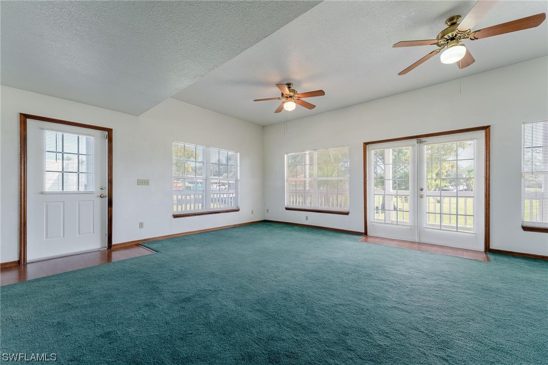 300 1st Street Moore Haven, FL 33471 - Photo 20 of 45 a view of an empty room with window chandelier fan and front door