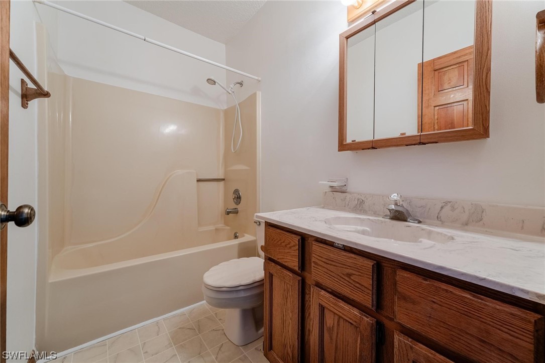 300 1st Street Moore Haven, FL 33471 - Photo 31 of 45 a bathroom with a granite countertop sink toilet and shower