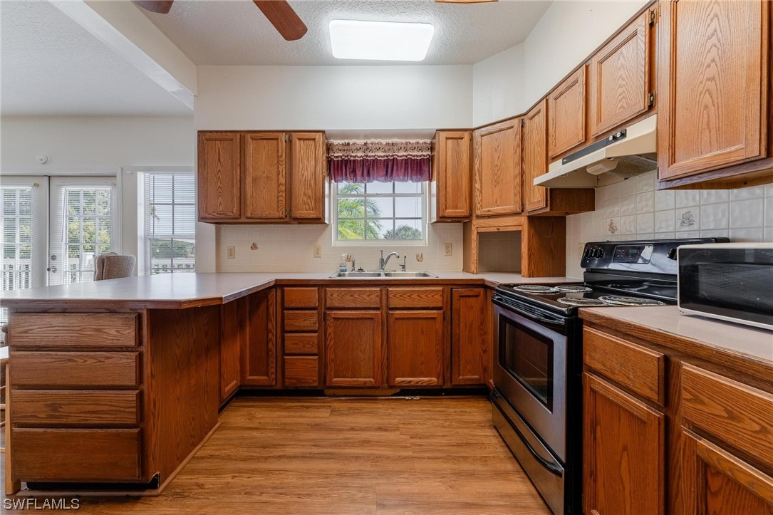 300 1st Street Moore Haven, FL 33471 - Photo 36 of 45 a kitchen with stainless steel appliances granite countertop a sink stove and cabinets