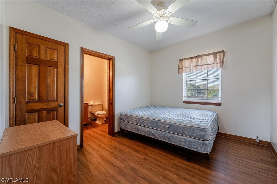 300 1st Street Moore Haven, FL 33471 - Photo 37 of 45 a bedroom with a bed and wooden floor