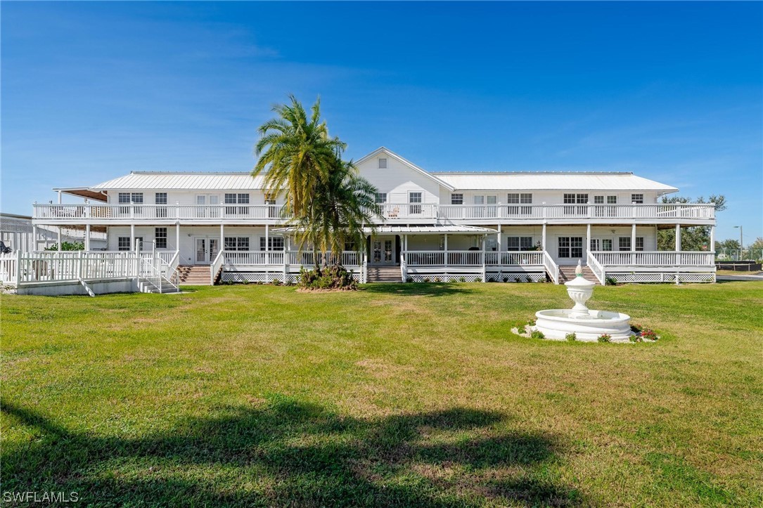 300 1st Street Moore Haven, FL 33471 - Photo 7 of 45 a view of a swimming pool with a lawn chairs