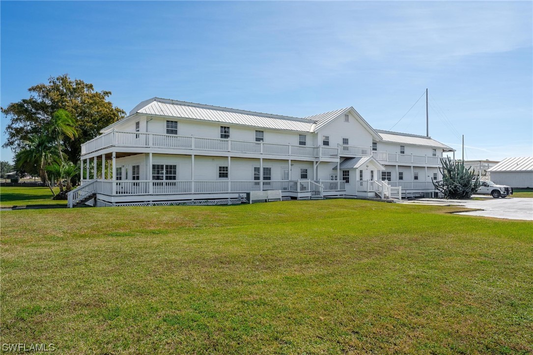 300 1st Street Moore Haven, FL 33471 - Photo 8 of 45 a front view of a house with swimming pool