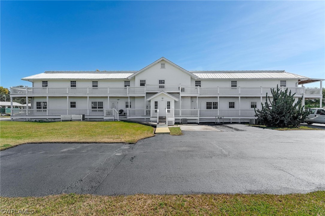 300 1st Street Moore Haven, FL 33471 - Photo 9 of 45 a view of a large white building with a swimming pool