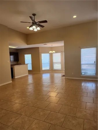 a view of a livingroom with a ceiling fan and window
