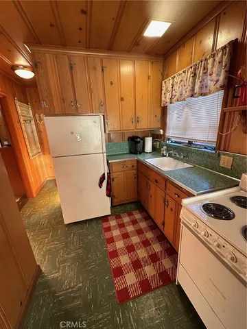 a kitchen with a stove a sink and a refrigerator