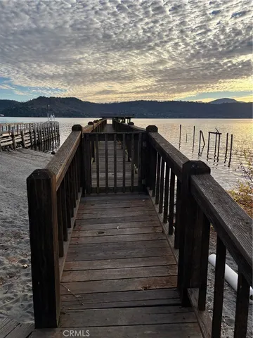 a view of a balcony with wooden floor and fence
