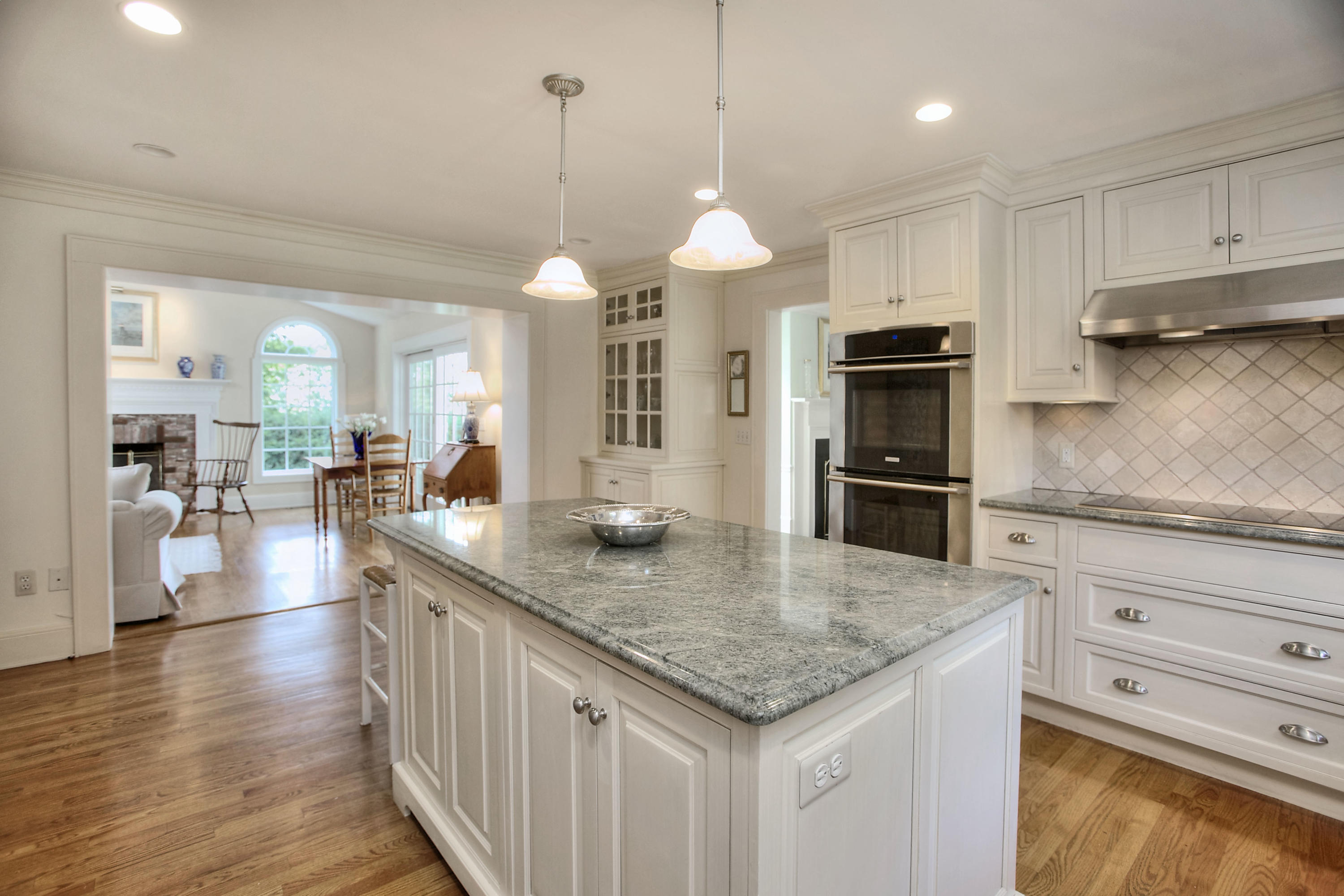 9 Sunswyck Road Darien, CT 06820 - Photo 18 of 43 a kitchen with stainless steel appliances granite countertop a sink a stove and a wooden floors