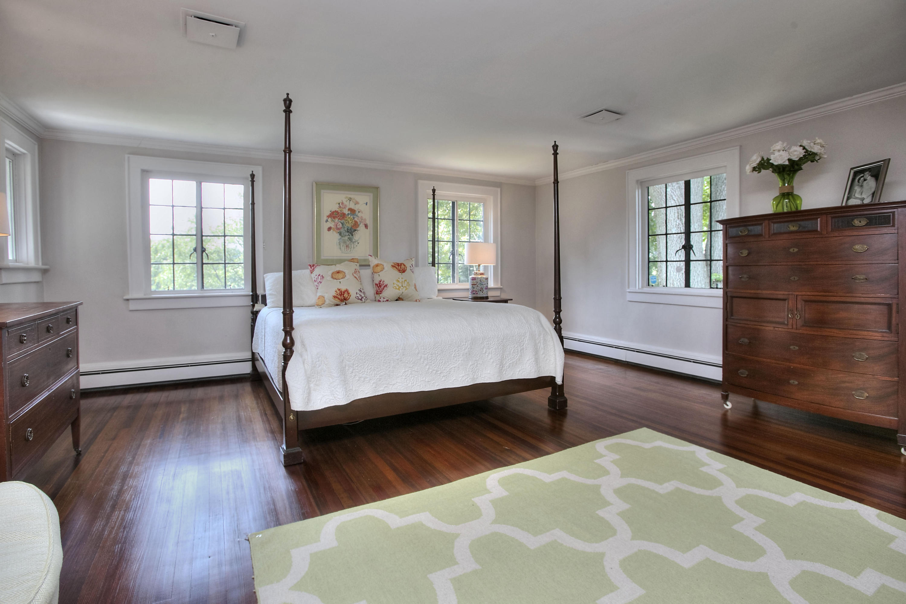 9 Sunswyck Road Darien, CT 06820 - Photo 21 of 43 a bedroom with a bed wooden floor and window