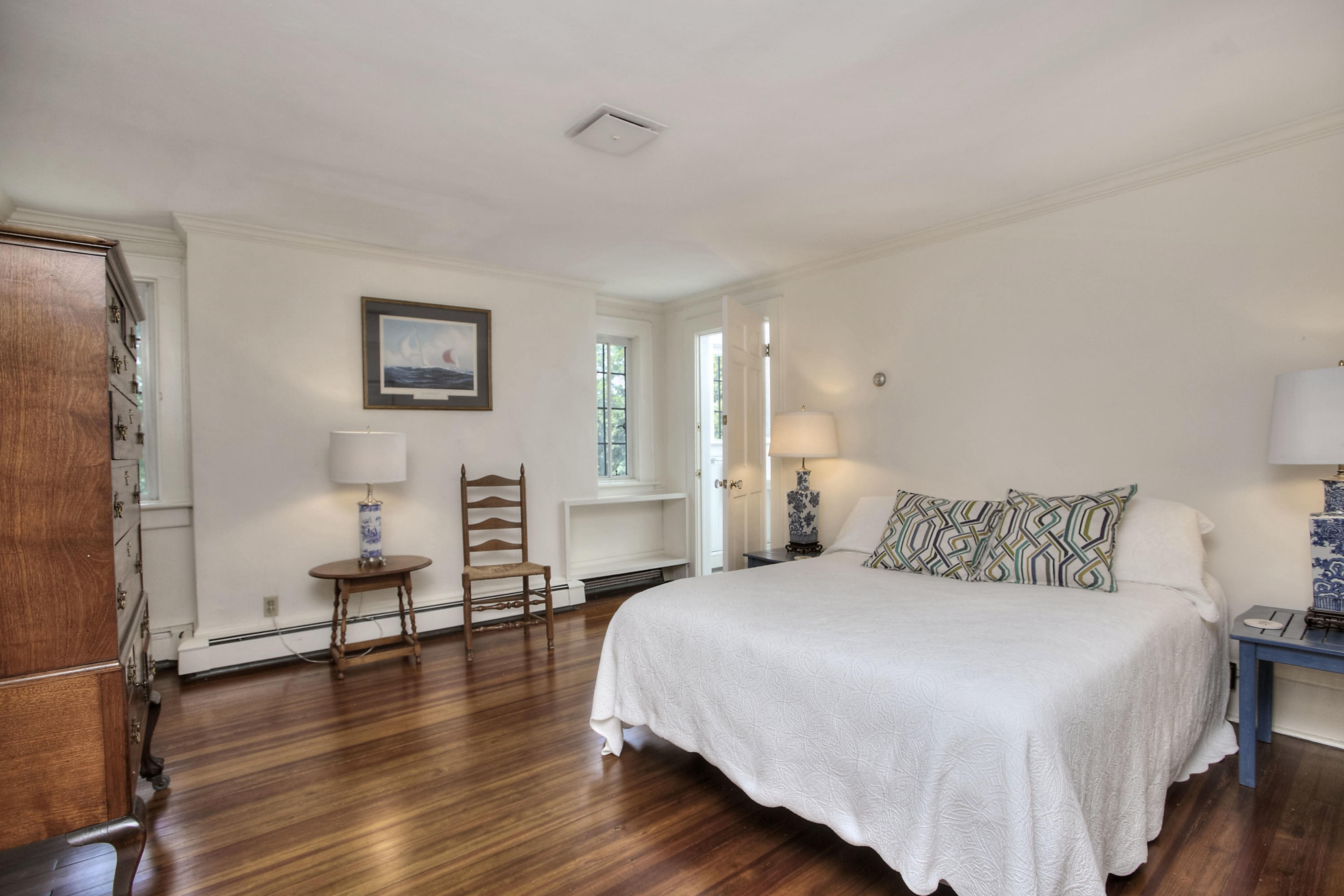 9 Sunswyck Road Darien, CT 06820 - Photo 25 of 43 a bedroom with a bed and wooden floor