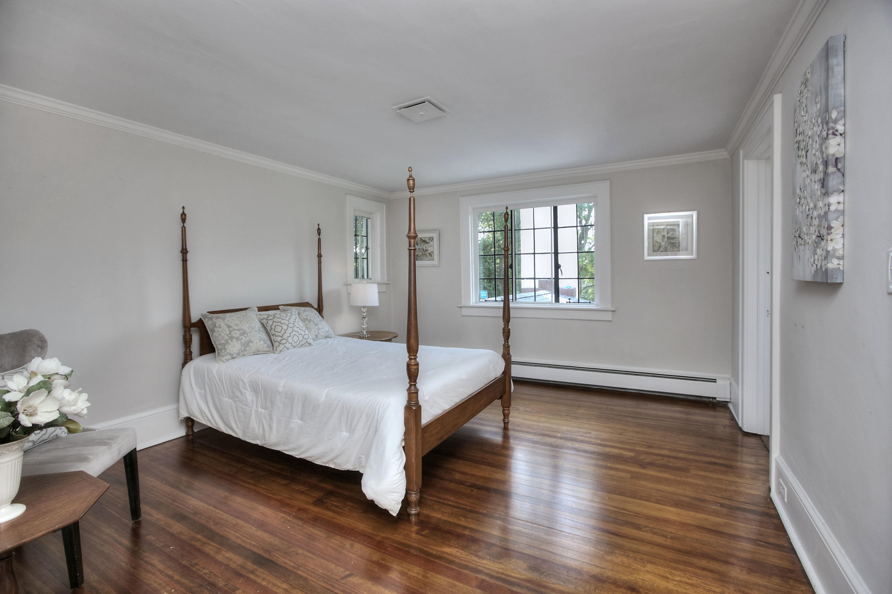 9 Sunswyck Road Darien, CT 06820 - Photo 26 of 43 a bedroom with a bed and wooden floor