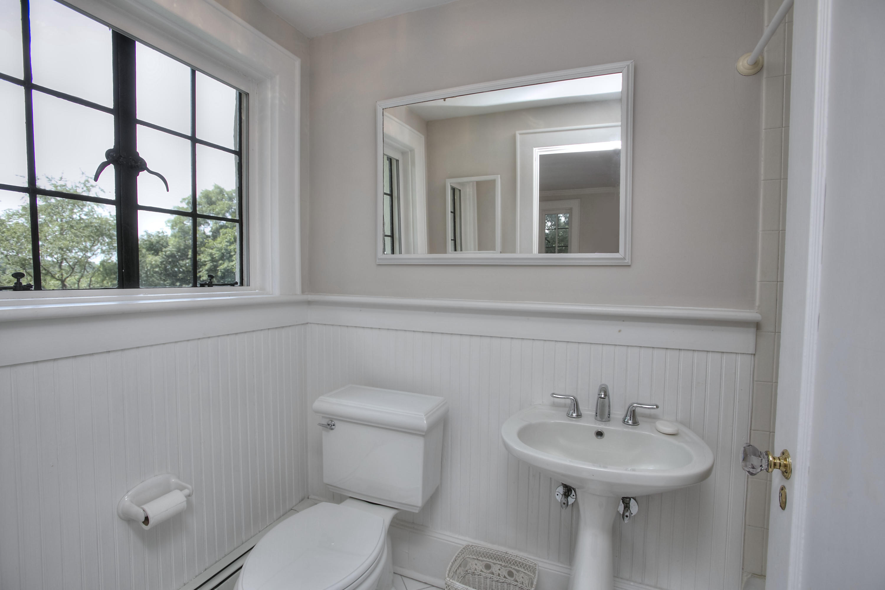 9 Sunswyck Road Darien, CT 06820 - Photo 30 of 43 a bathroom with a toilet sink and mirror
