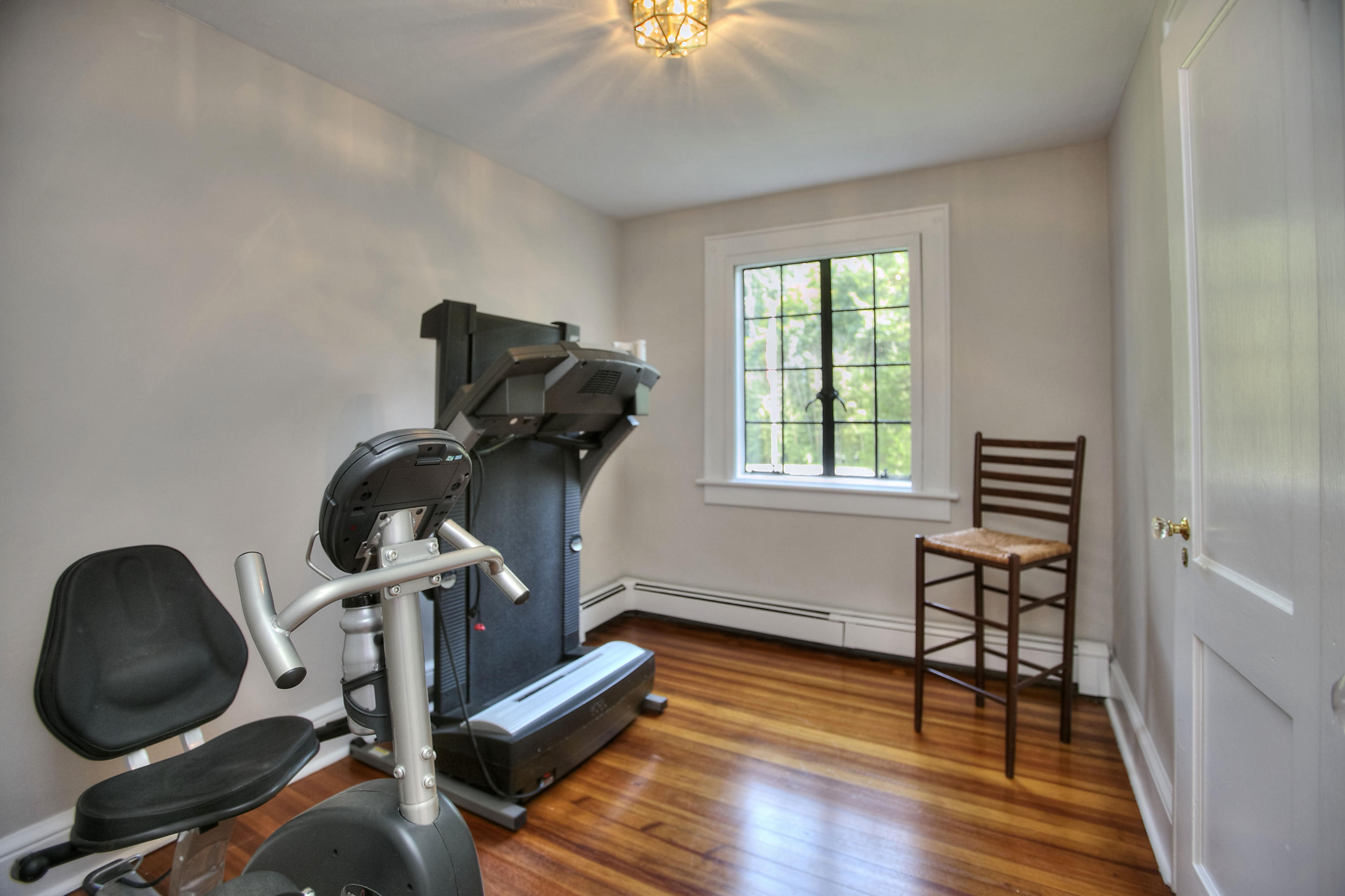 9 Sunswyck Road Darien, CT 06820 - Photo 33 of 43 a view of workspace with wooden floor windows gym equipment and windows