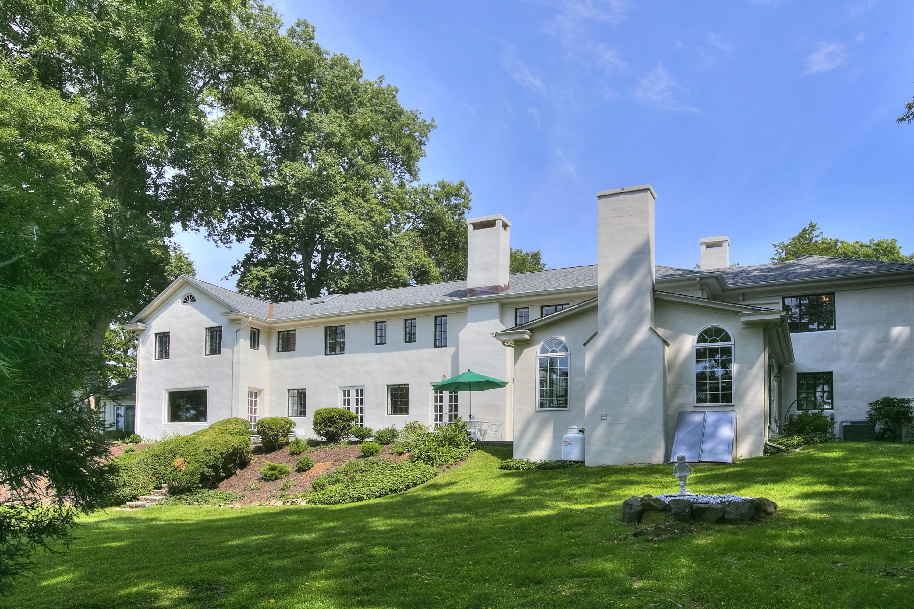 9 Sunswyck Road Darien, CT 06820 - Photo 39 of 43 a front view of a house with a garden and plants