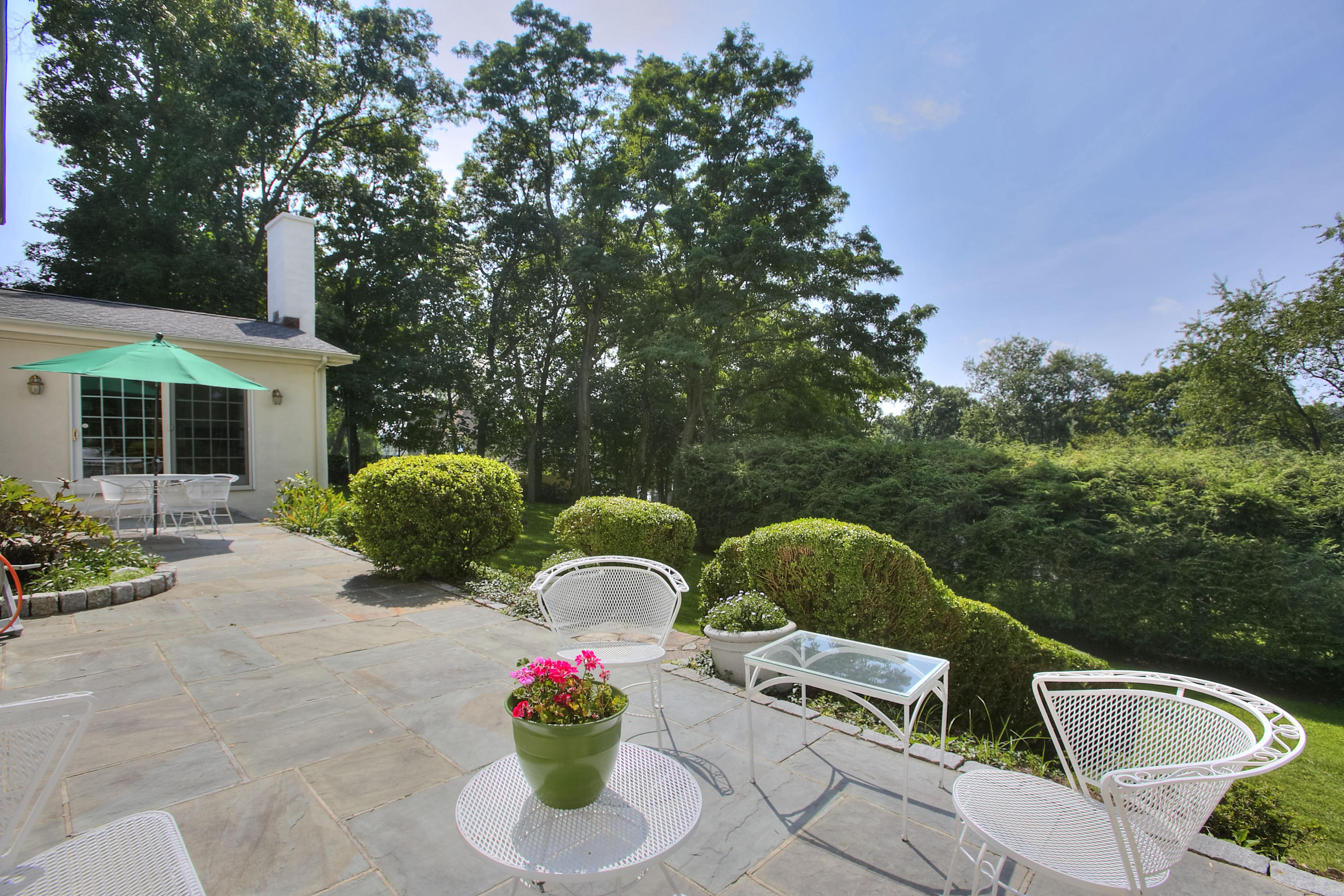 9 Sunswyck Road Darien, CT 06820 - Photo 40 of 43 a view of backyard with swimming pool and outdoor seating