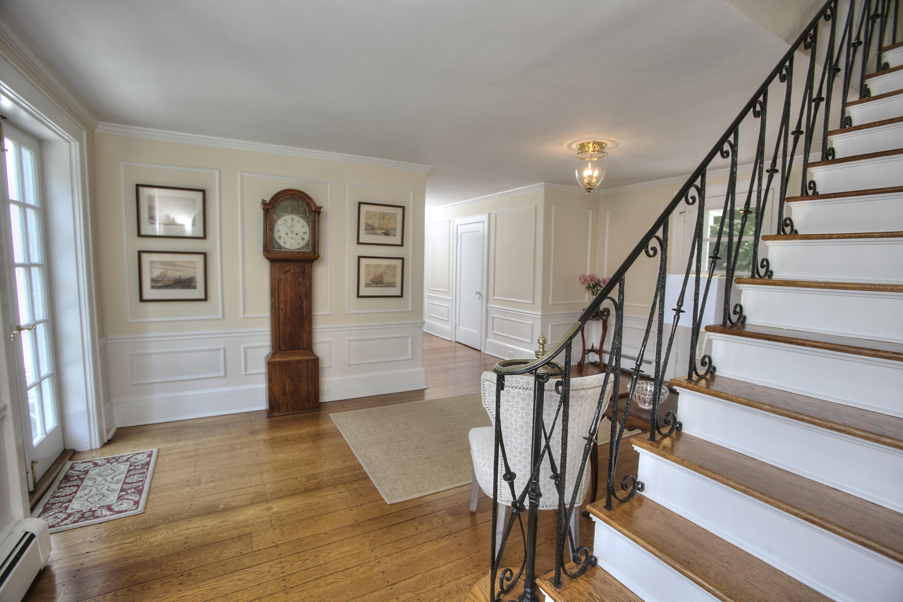 9 Sunswyck Road Darien, CT 06820 - Photo 6 of 43 a view of a hallway with wooden floor and staircase