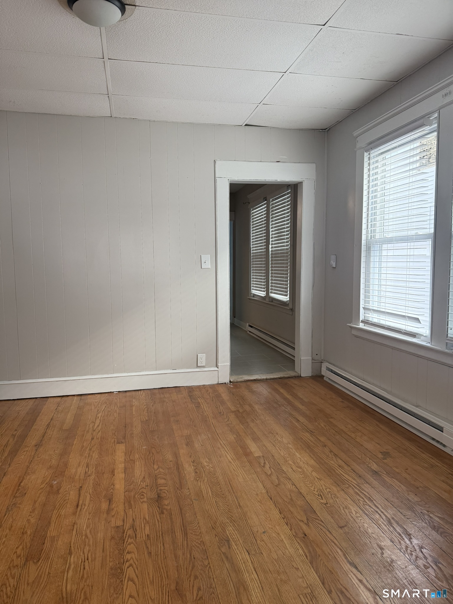 158 Alder Street, Unit 3 Waterbury, CT 06708 - Photo 12 of 19 wooden floor in an empty room with a window