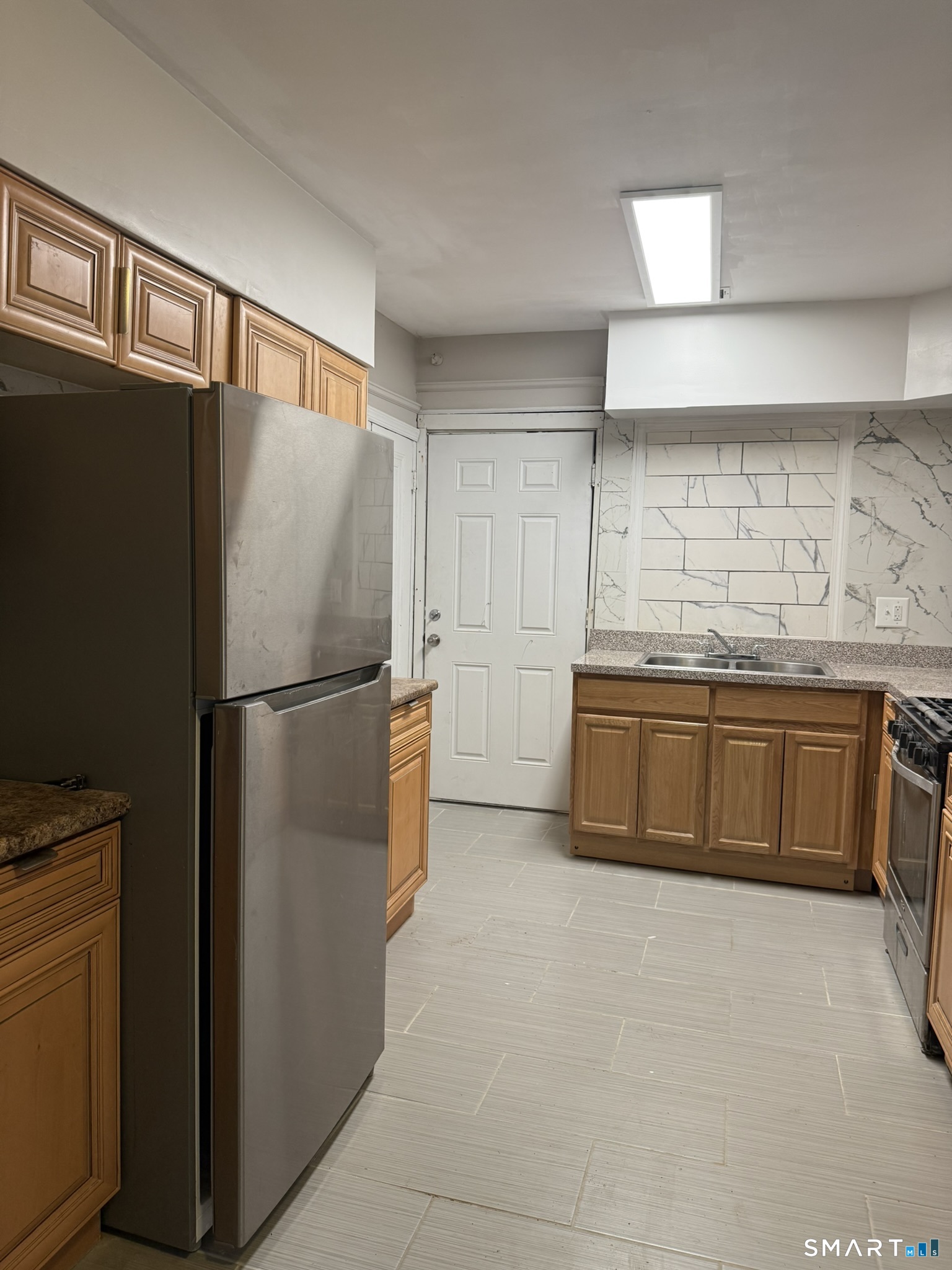 158 Alder Street, Unit 3 Waterbury, CT 06708 - Photo 15 of 19 a kitchen with stainless steel appliances a refrigerator and a sink