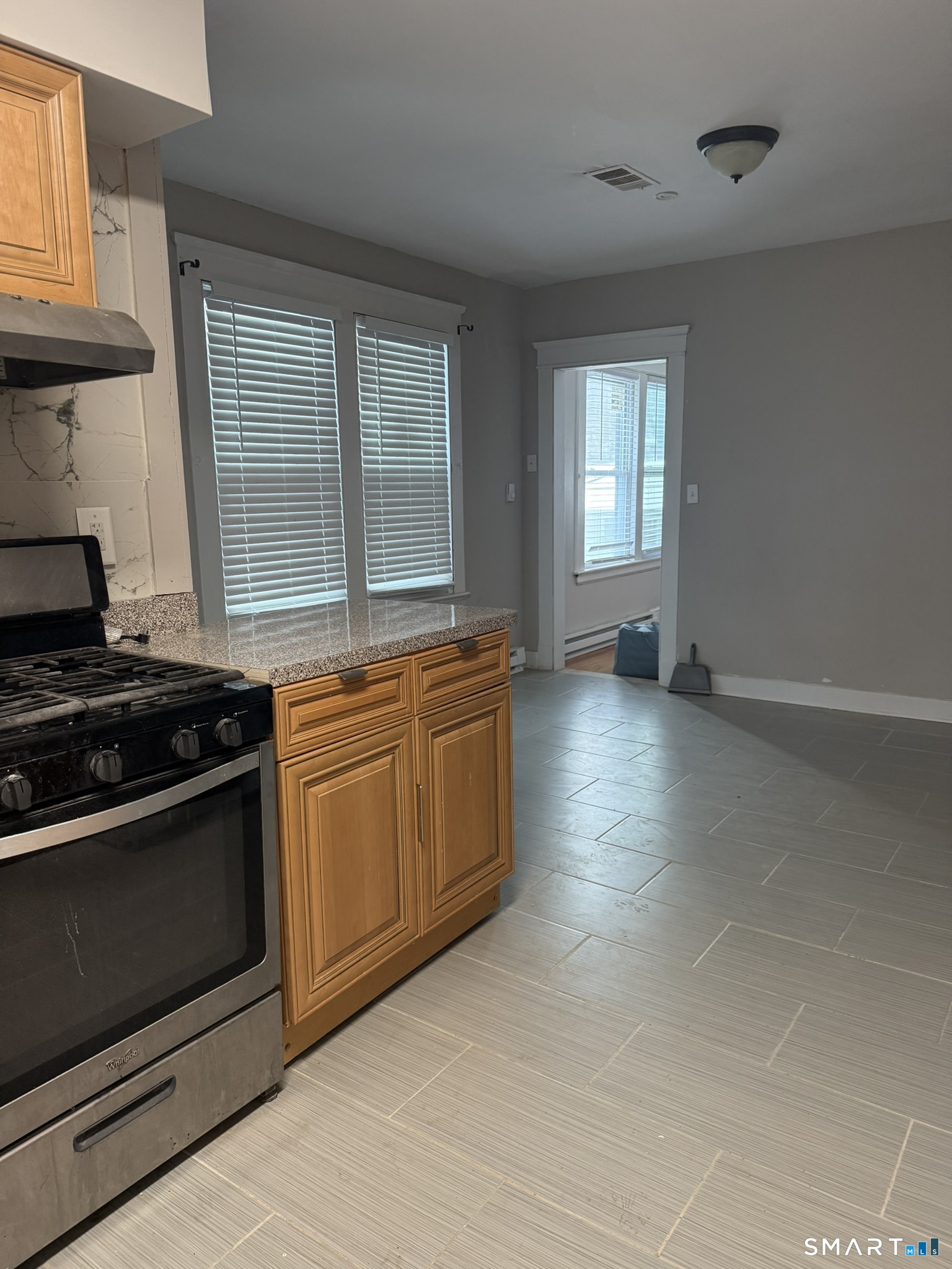 158 Alder Street, Unit 3 Waterbury, CT 06708 - Photo 16 of 19 a kitchen with granite countertop a stove and a sink