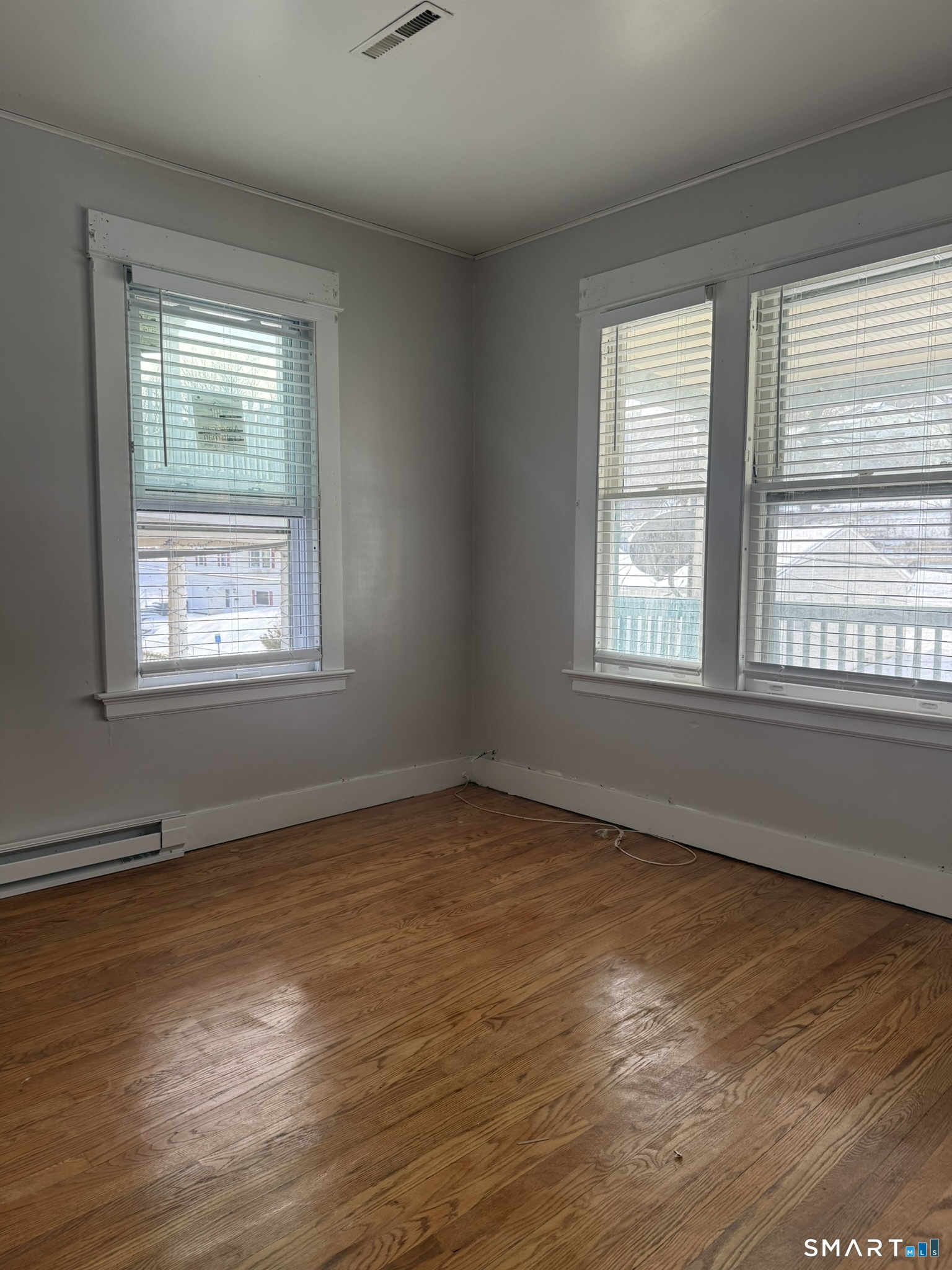 158 Alder Street, Unit 3 Waterbury, CT 06708 - Photo 3 of 19 an empty room with wooden floor and windows