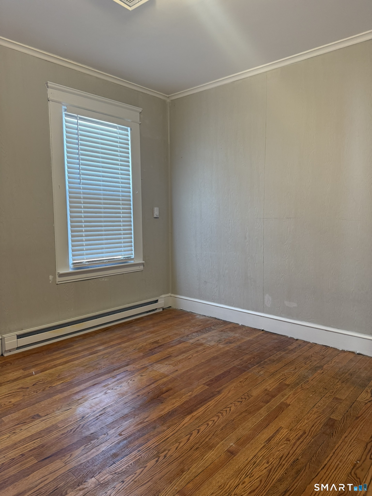 158 Alder Street, Unit 3 Waterbury, CT 06708 - Photo 6 of 19 a view of an empty room with wooden floor and a window