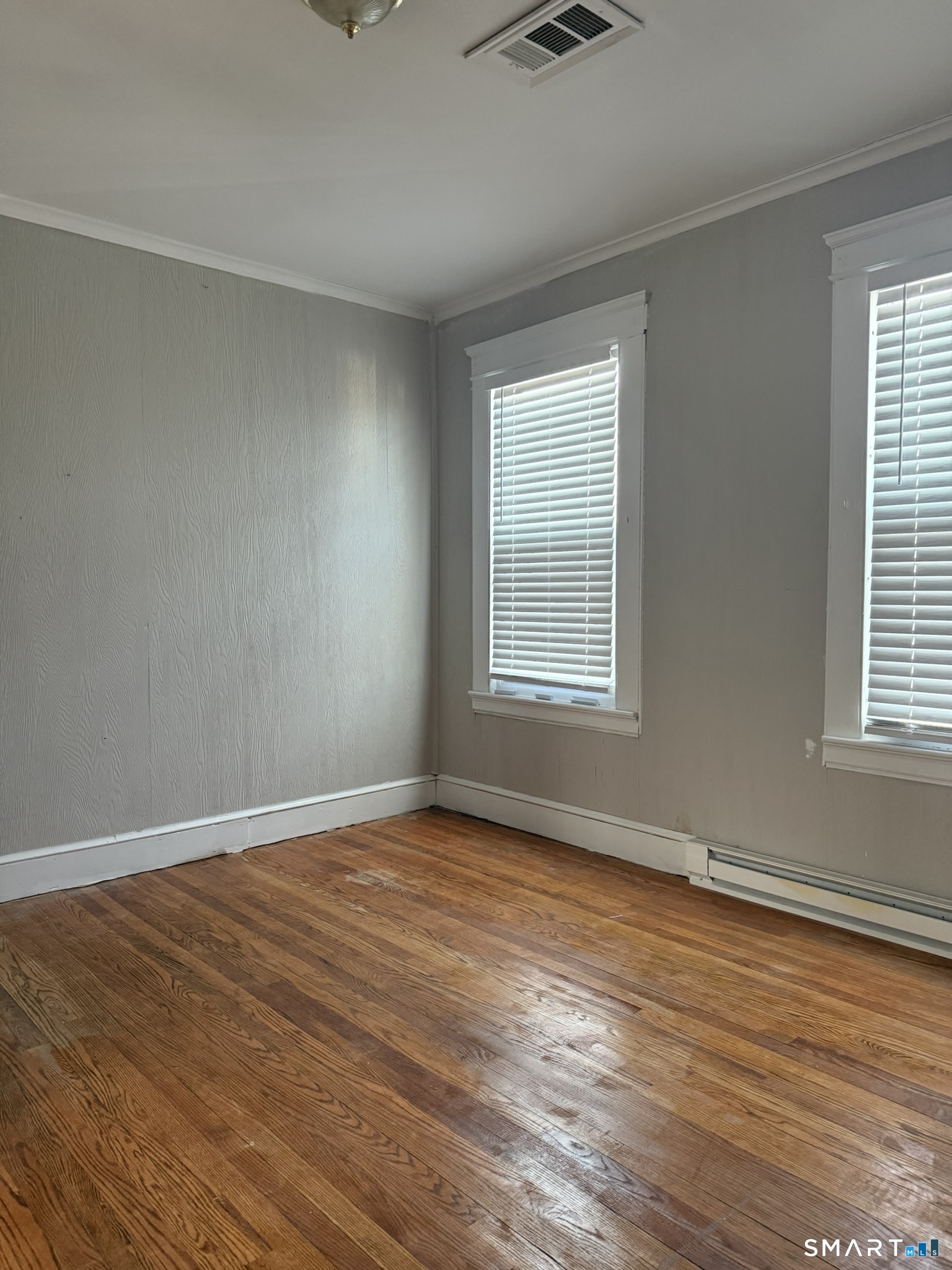 158 Alder Street, Unit 3 Waterbury, CT 06708 - Photo 7 of 19 a view of an empty room with wooden floor and a window