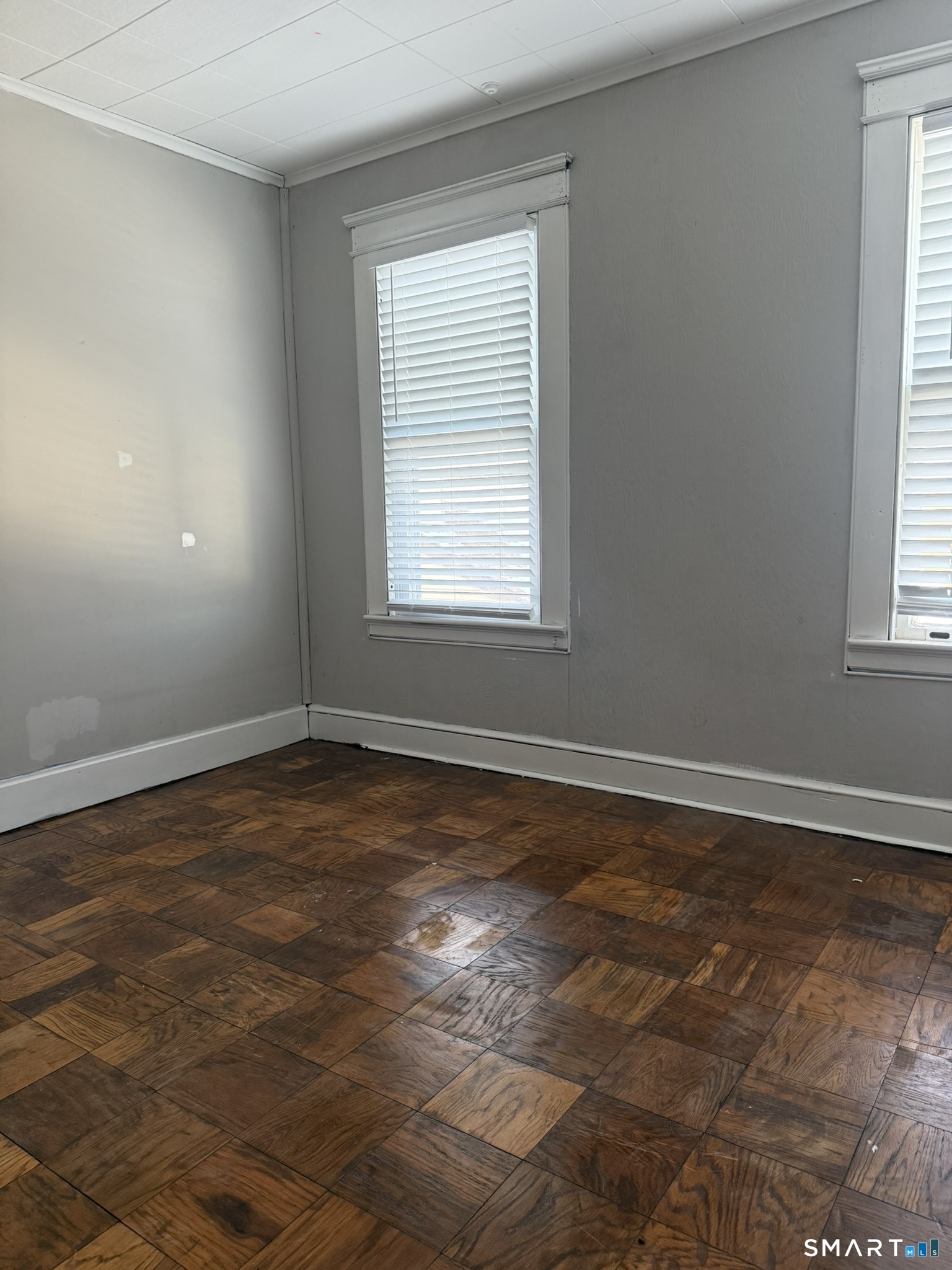 158 Alder Street, Unit 3 Waterbury, CT 06708 - Photo 8 of 19 a view of an empty room with wooden floor and a window