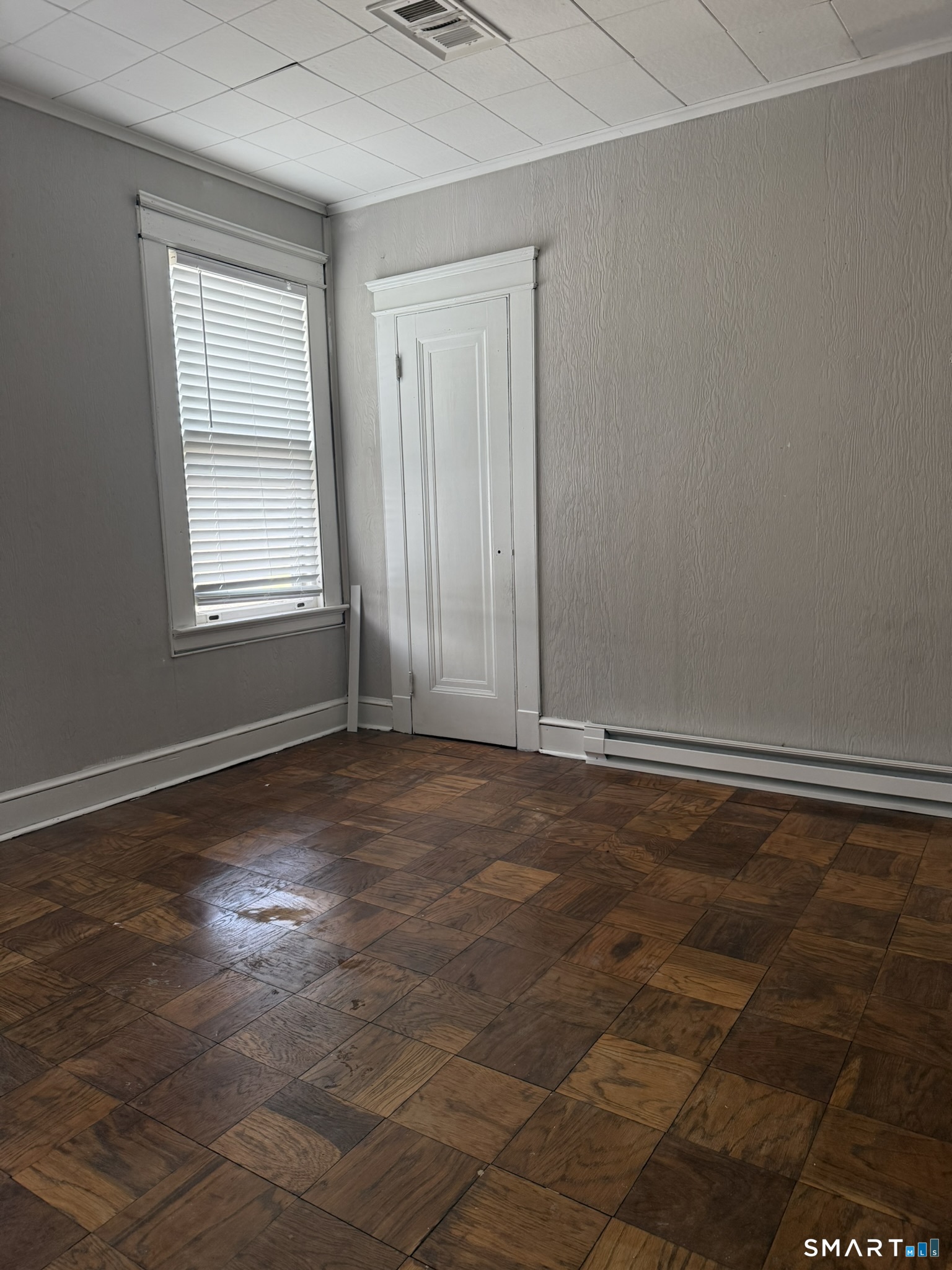 158 Alder Street, Unit 3 Waterbury, CT 06708 - Photo 9 of 19 an empty room with wooden floor and windows