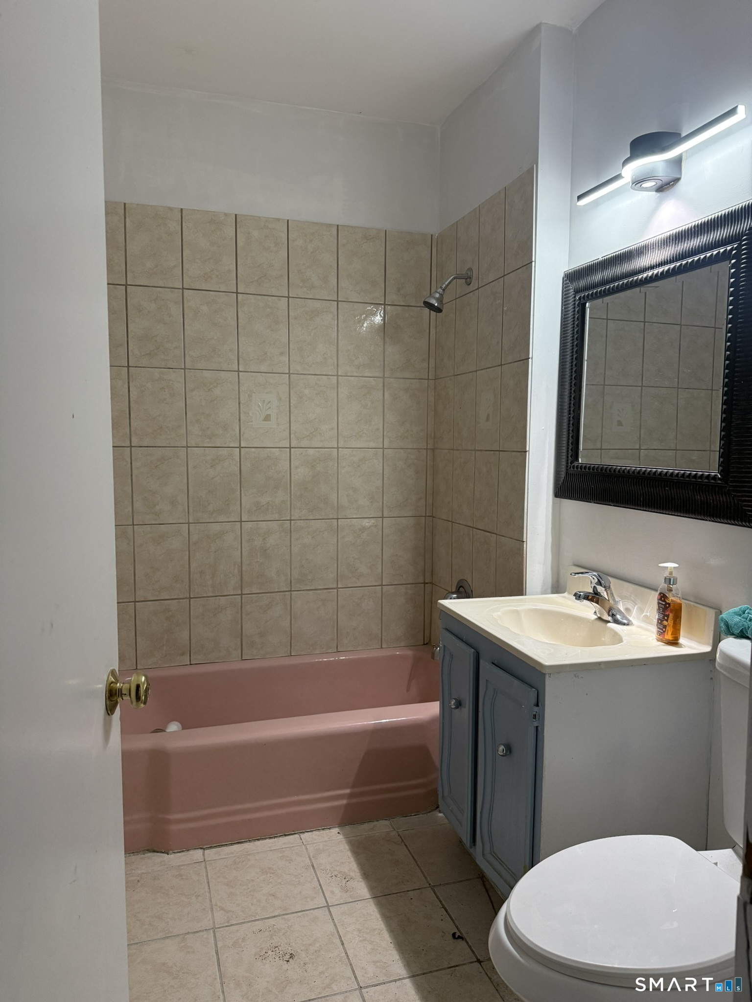158 Alder Street, Unit 3 Waterbury, CT 06708 - Photo 10 of 19 a bathroom with a bathtub sink vanity mirror and toilet