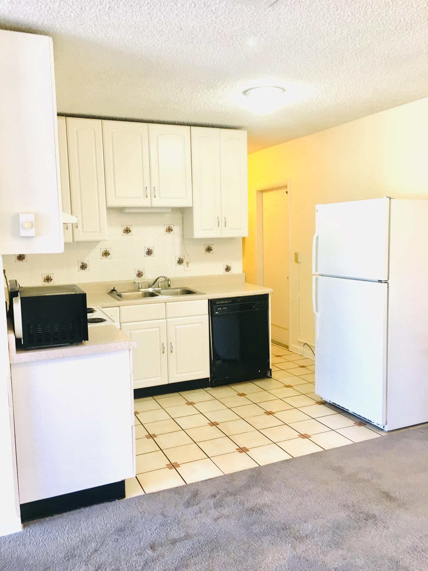 321 Winged Foot Road Palm Springs, FL 33461 - Photo 17 of 30 a kitchen with a sink a stove and a refrigerator