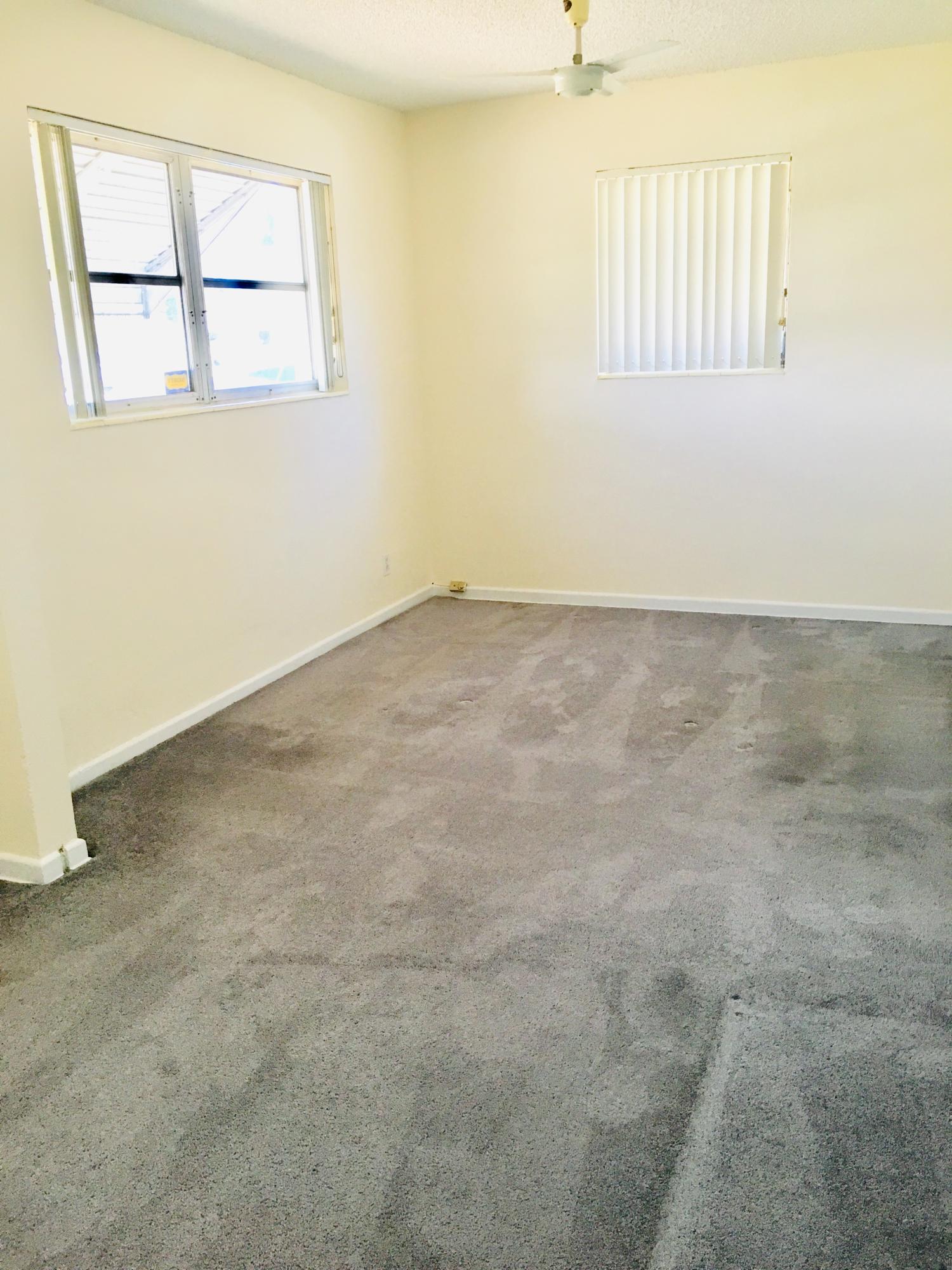 321 Winged Foot Road Palm Springs, FL 33461 - Photo 24 of 30 an empty room with windows