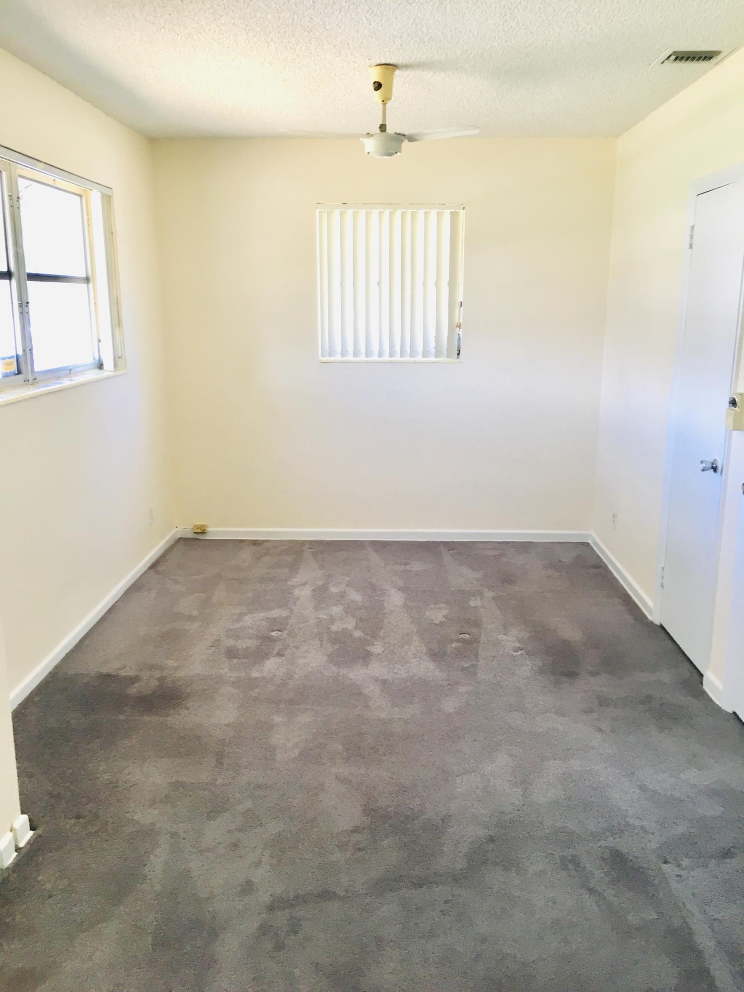 321 Winged Foot Road Palm Springs, FL 33461 - Photo 25 of 30 an empty room with windows
