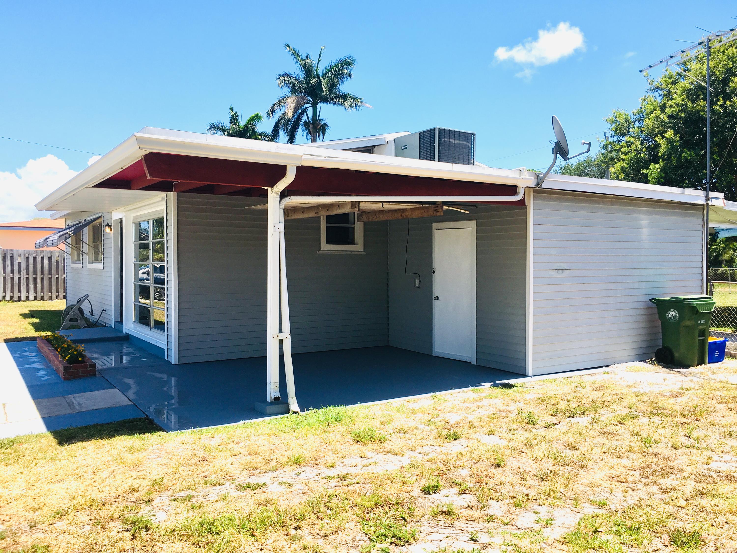 321 Winged Foot Road Palm Springs, FL 33461 - Photo 6 of 30 a side view of a house with a yard