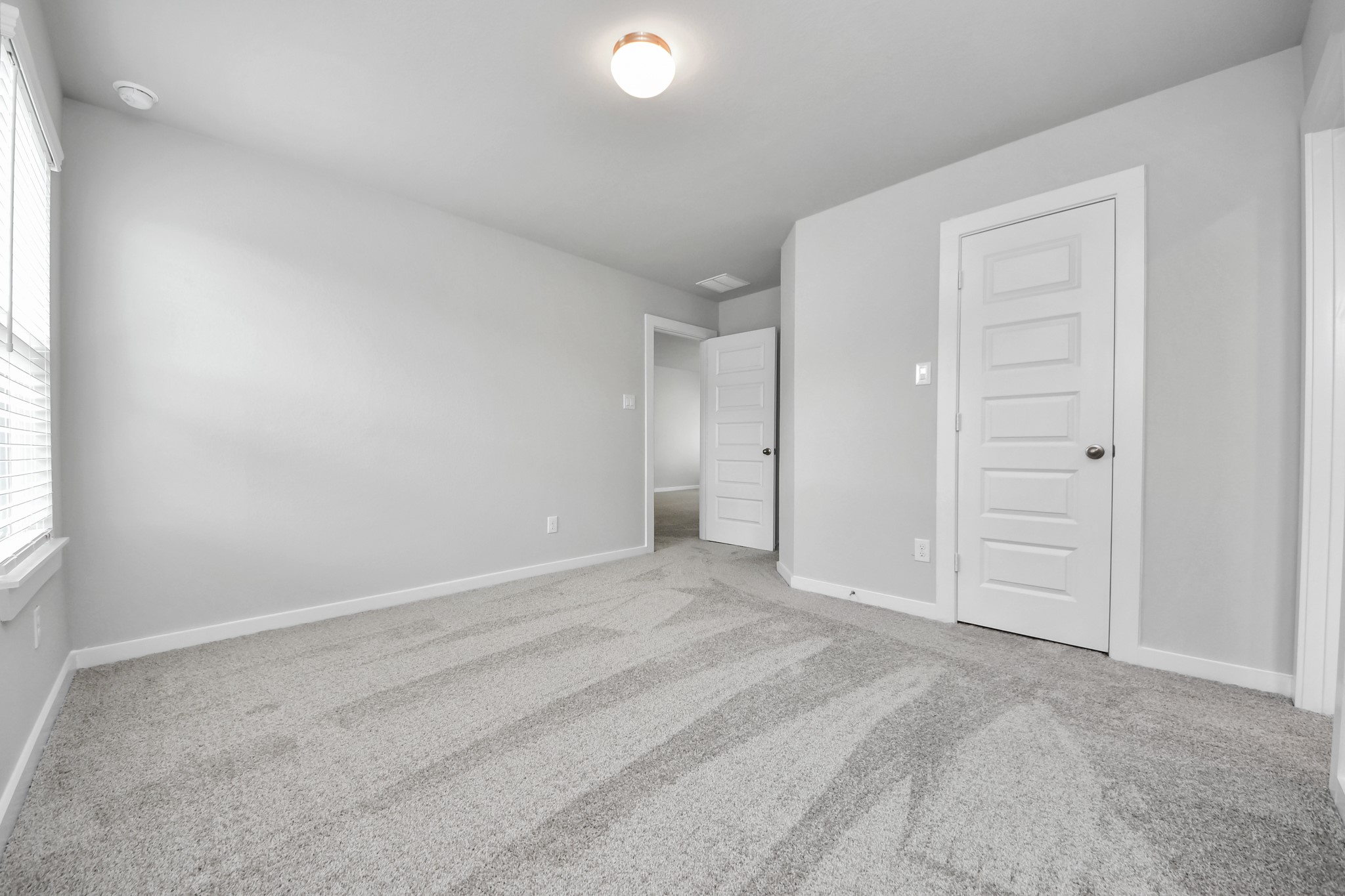 11106 Tulip Rdg Trail Houston, TX 77044 - Photo 31 of 34 Generously sized secondary bedrooms featuring spacious closets, soft and inviting carpeting underfoot, large windows allowing plenty of natural light, and the added touch of privacy blinds for your personal retreat. Sample photo of completed home with similar floor plan. Actual colors and selections may vary.