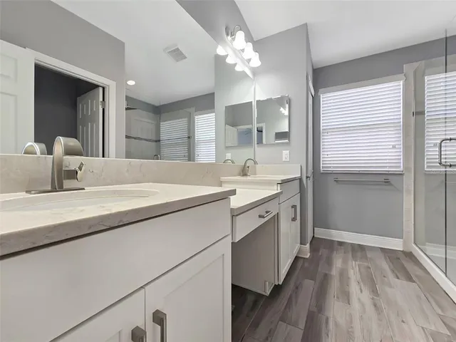 a bathroom with a glass shower door