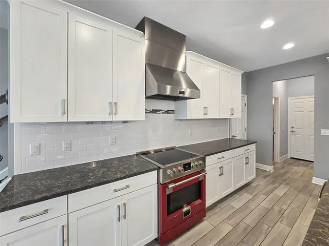 a kitchen with stainless steel appliances granite countertop a sink a stove and a granite counter tops