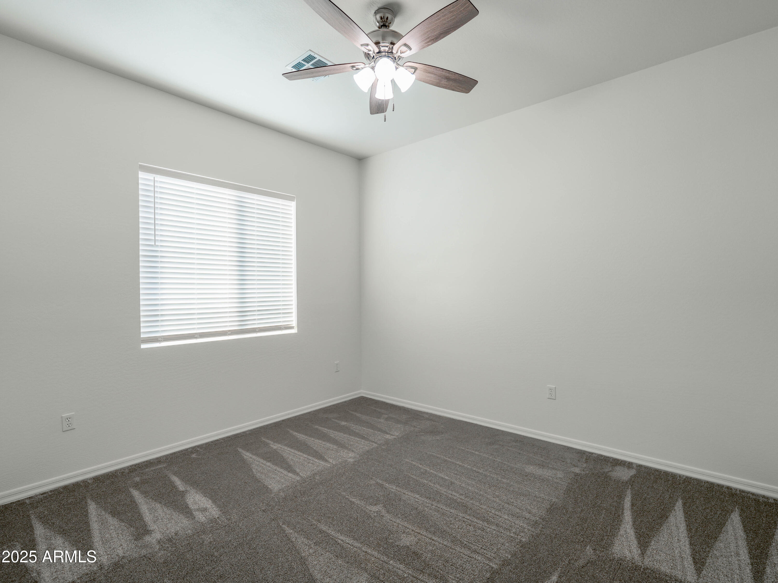 14554 South Diablo Road Arizona City, AZ 85123 - Photo 12 of 33 a view of a room with a ceiling fan and a window