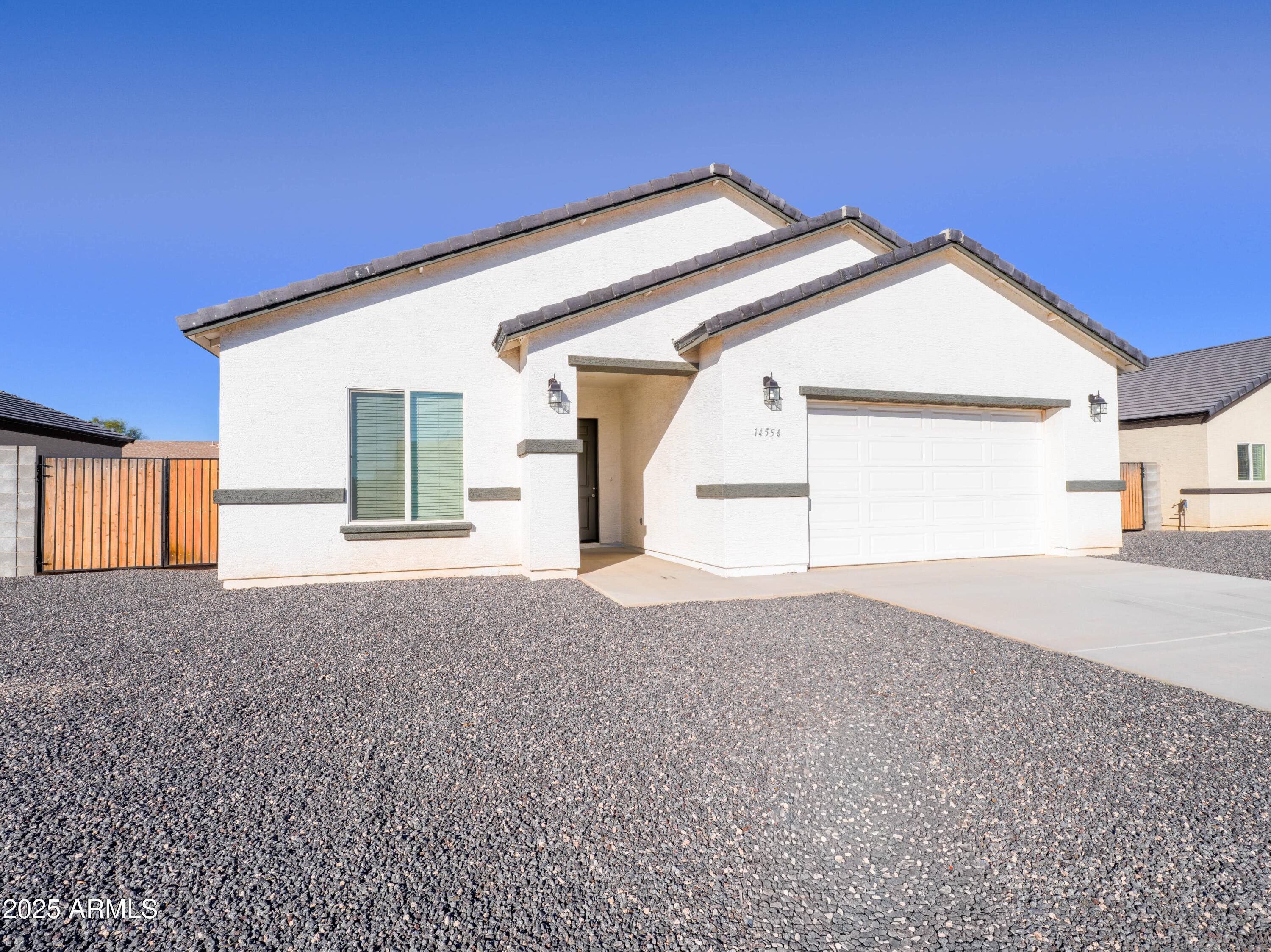14554 South Diablo Road Arizona City, AZ 85123 - Photo 31 of 33 a view of a house with a yard and garage
