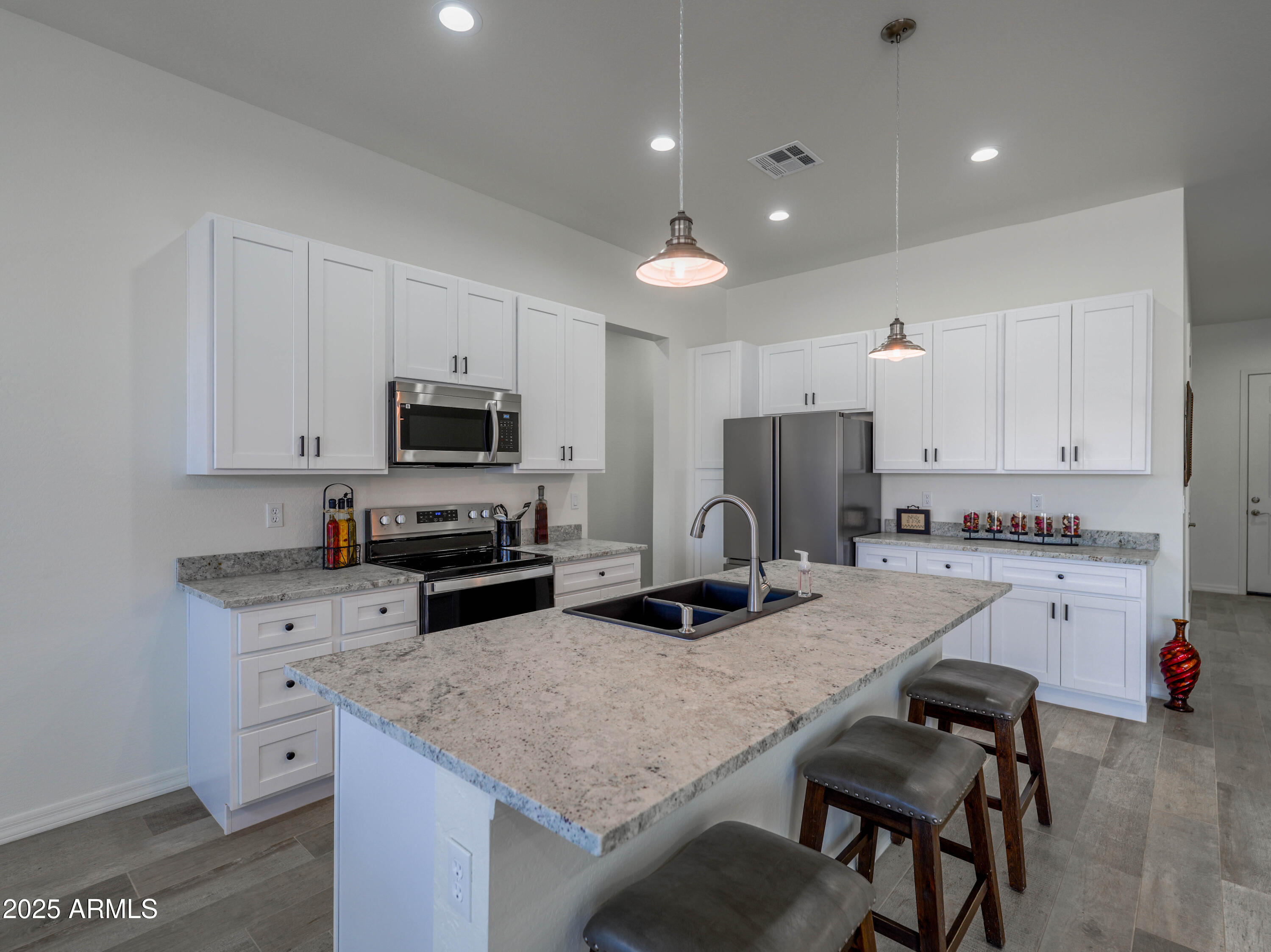 14554 South Diablo Road Arizona City, AZ 85123 - Photo 6 of 33 a kitchen with granite countertop kitchen island sink refrigerator and cabinets