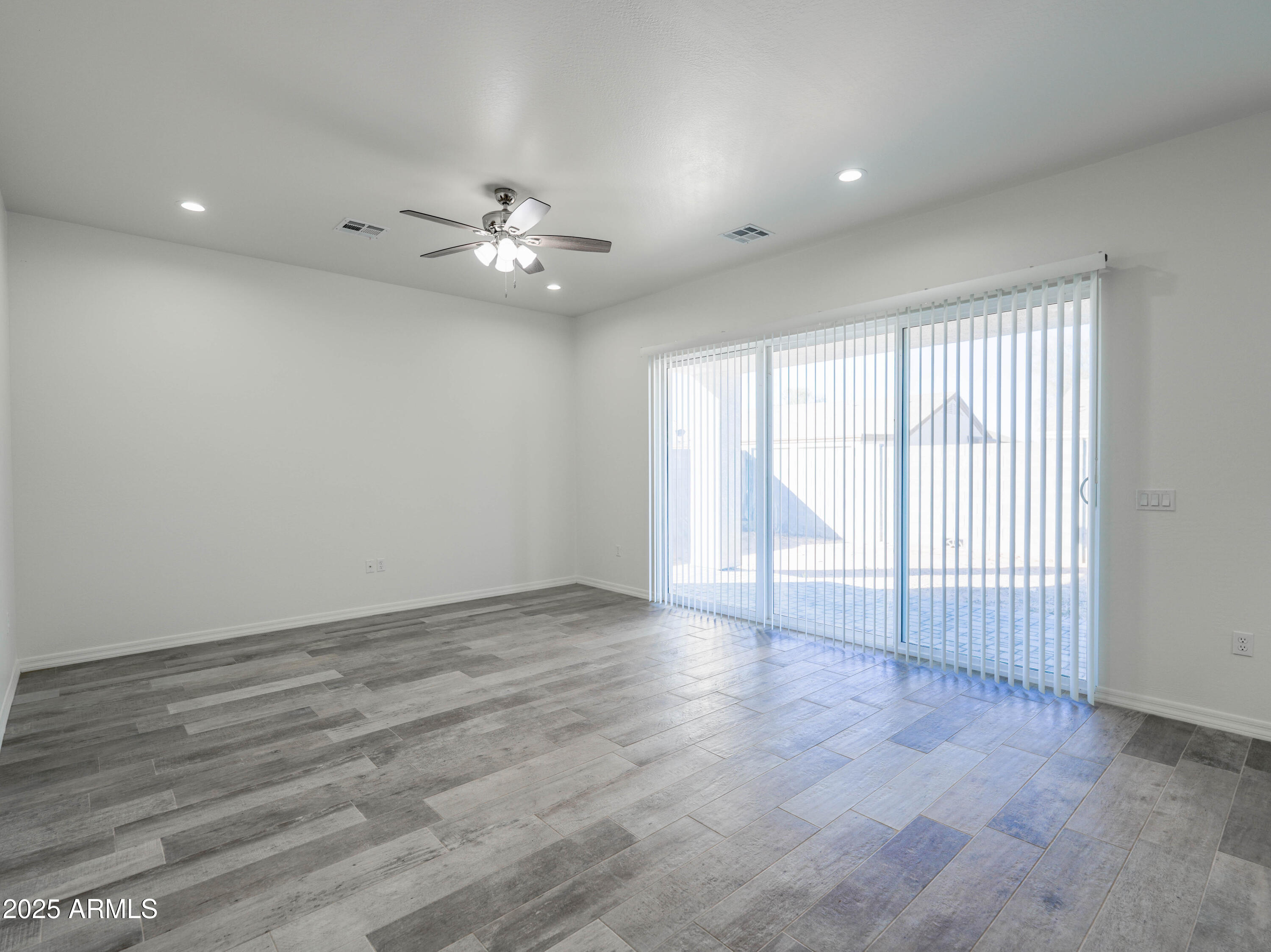 14554 South Diablo Road Arizona City, AZ 85123 - Photo 9 of 33 an empty room with wooden floor and windows