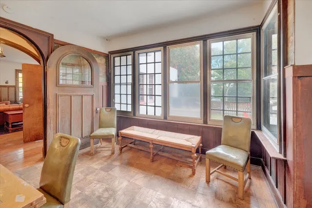 a living room with furniture a flat screen tv and a table